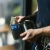 Photograph of Person Holding Black Leather Wallet with Money