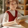 Girl in White and Red Crew Neck T-shirt Using Tablet