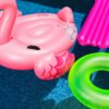 pink inflatable flamingo and green inflatable ring