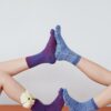 Women Touching Feet in Socks