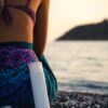 woman sitting on rocky shore during day